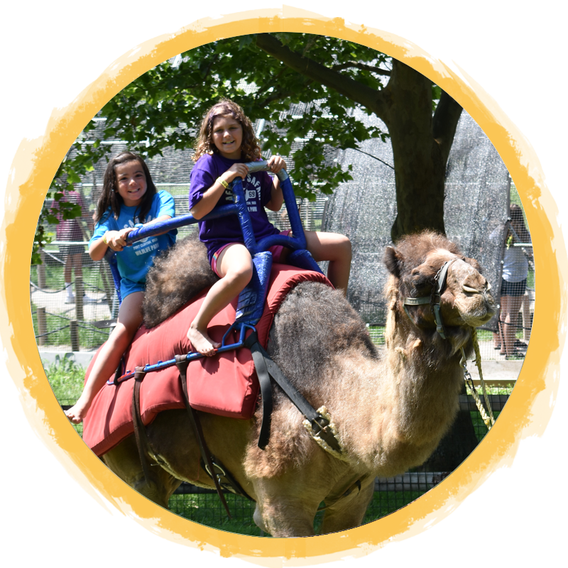 2 girls riding a camel circle